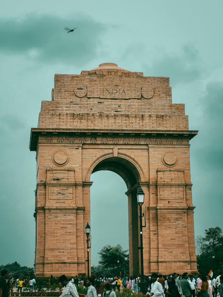 pexels photo 30581835 30581835 A view of the iconic India Gate in New Delhi with a crowd gathered underneath and a cloudy sky.